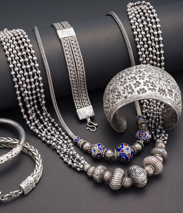 Collection of antique traditional silver jewelry on black paper